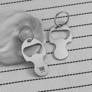 Macro shot of stainless steel shopping trolley token keychain and bottle opener tool