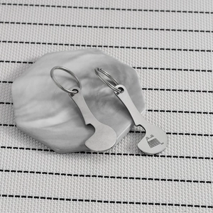 Macro view of stainless steel trolley tokens with shopping cart icons on a tray