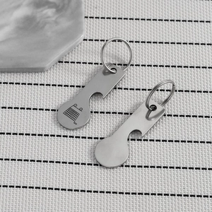 Detail of stainless steel trolley token keychain and bottle opener with engraved icon