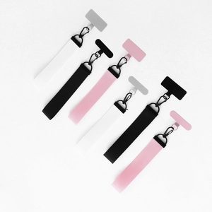 Detail of woven phone wrist strap set with stainless steel patch in black pink and white