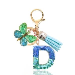 Blue glitter resin letter D keychain with butterfly charm and tassel on gold ring