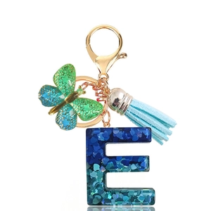 Letter E keychain with blue sequins resin, butterfly charm and light blue tassel