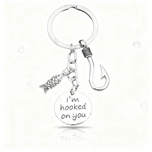 Silver fish and hook keychain set with I'm Hooked on You engraved disc on white background