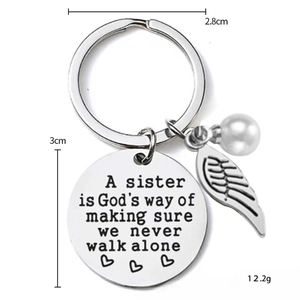 Polished stainless steel sister keychain with feather charm, pearl, and engraved round tag