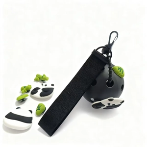 Detailed view of black pickleball keychain with panda and bamboo leaf charm attachments
