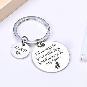 Macro detail of stainless steel keychain with Dad heart charm and father-son silhouette