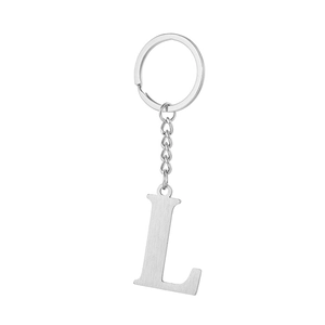 Macro shot of silver letter L keychain with brushed metal texture and round ring