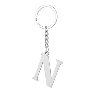 Macro shot of silver stainless steel letter N keychain with a polished metal finish