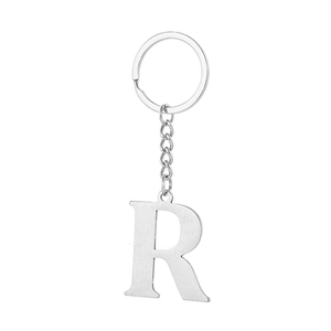 Detail view of silver stainless steel letter R keychain with brushed metal finish