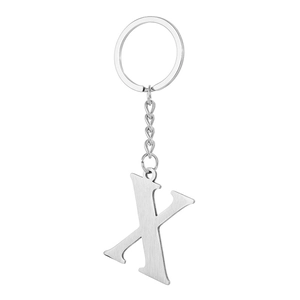 Macro view of silver stainless steel letter X keychain with brushed metal texture