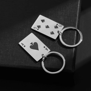 Detailed close-up of Ace and Five of Spades stainless steel playing card keychains