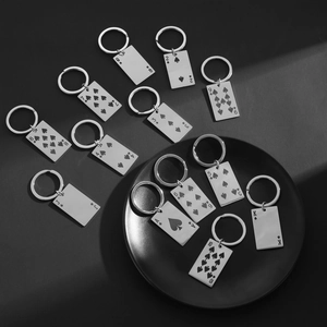 Artistic layout of 13 spade playing card keychains with polished metallic finish
