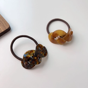 Macro detail of cellulose acetate twisted rings and elastic bands with handmade engraving
