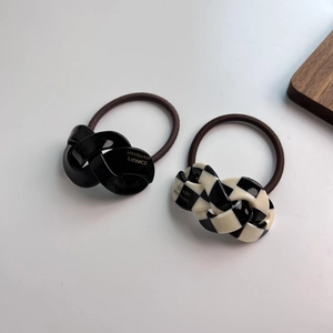 Handmade acetate twist hair ties in black and checkerboard patterns for ponytails