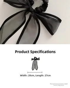 Detail showing elegant black organza bow scrunchie with long ribbons, size 20x27cm
