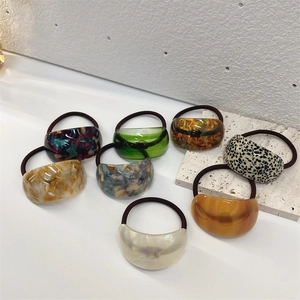 Detailed view of high-elasticity hair ties featuring assorted acetate pattern decorations