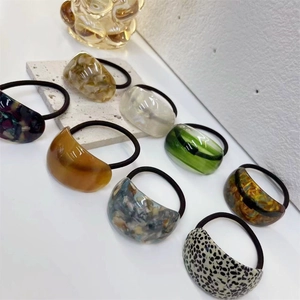 Macro detail of assorted acetate hair ties with marble and tortoiseshell patterns