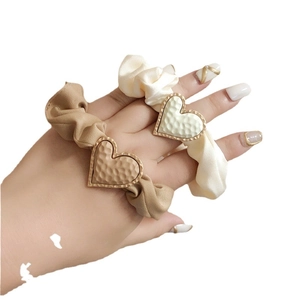 Satin scrunchie set with matte heart charms in cream and khaki for elegant hair styling