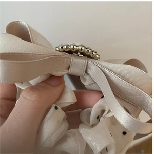 Elegant champagne satin bow scrunchie with pearls and polka dot chiffon accents