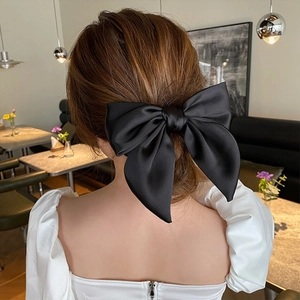 Elegant large black satin bow hair tie for high ponytail styling on back of head