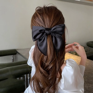 Elegant large black satin bow hair tie for ponytail or bun hairstyles for women