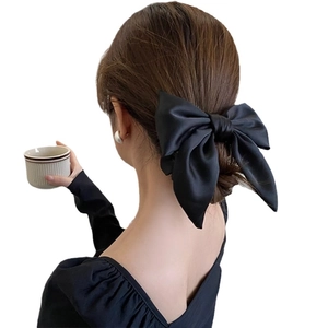 Elegant large black satin bow hair tie for women's high ponytail or bun styling