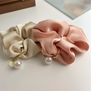 Elegant satin hair scrunchies in champagne and pink with pearl and heart lucky charms