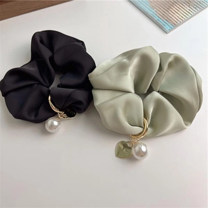 Elegant satin silk scrunchies in black and sage green with heart charms and white pearls