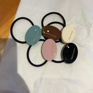 Detail von fünf elastischen Haarbändern mit France Handmade Goldlabel auf Harzperlen