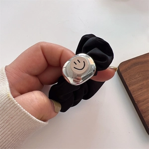 Elegant black pleated scrunchie featuring a metallic square piece with pink smiley face