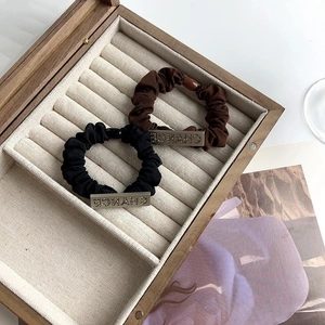 Elegant scrunchie set with CHANCE rhinestone lettering on minimalist fabric hair ties