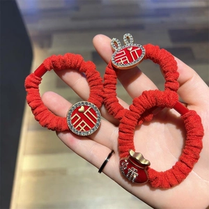 Festive red velvet hair scrunchies set with golden rabbit, fortune pouch, and fu charms
