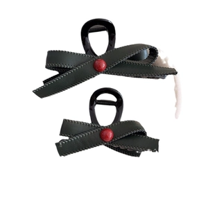 French vintage dark green bow hair claw set with red pearl accent on white background