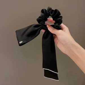 Elegant black satin bow hair tie with long ribbons and pearl accents for women