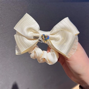 Cream bow scrunchie with sparkling heart rhinestone and handmade charm for hair styling