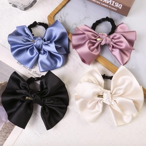 Set of four large satin bow hair scrunchies in blue, pink, black and cream colors
