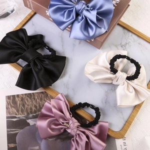 Elegant satin bow scrunchies set in blue, black, beige and pink for ponytail styling