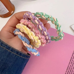 Detailed macro view of five macaron colored hand-woven high elasticity hair ties