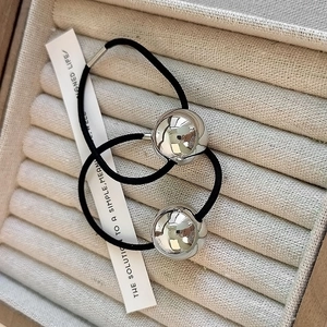 Set of two high-elastic black hair ties with polished silver metallic beads on velvet