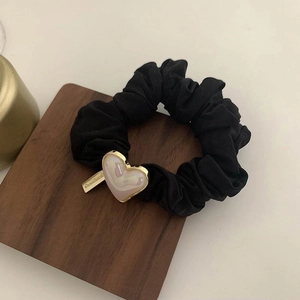Black fabric hair scrunchie with vintage pearlescent heart charm and metal tag