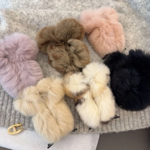 Plush square hair claws in assorted colors with a gold rhinestone D charm on soft knit background