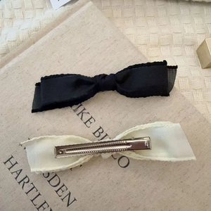 Elegant bow hair clips set in black and cream silk ribbons with metal duckbill clips
