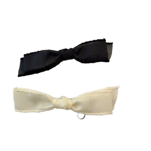 Elegant bow hair clips set in black and cream white with delicate textured fabric finish