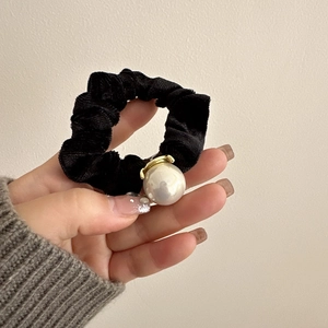 Elegant black velvet scrunchie with a large pearl decoration and gold metal clip