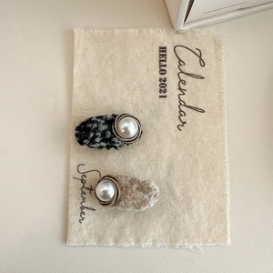 Detail of tweed and faux fur hair clips with large white pearls and gold metal trim