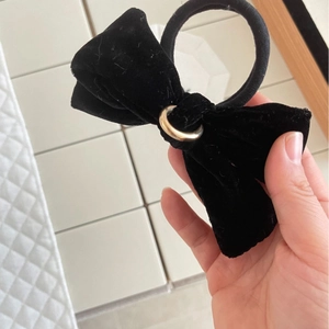 Elegant black velvet bow hair scrunchie with a gold metal center for ponytail