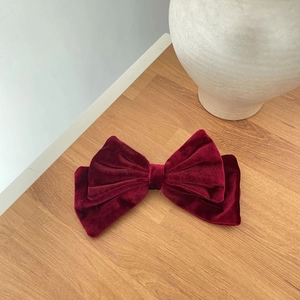 Elegant French vintage wine red velvet double bow hair tie on a wooden background