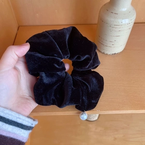 Velvet hair scrunchie in black with a white faux pearl charm for stylish hair styling