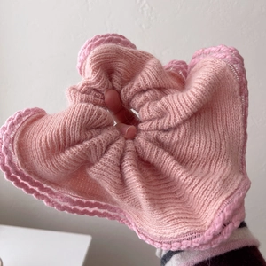 Pink oversized mink fur knit scrunchie with soft crochet texture and wavy edge design