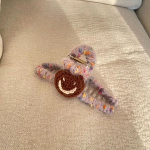 Plush wool shark hair claw clip with purple knit yarn and crochet smiley face design